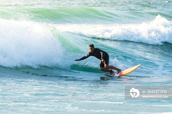 Surfer in action at sunset