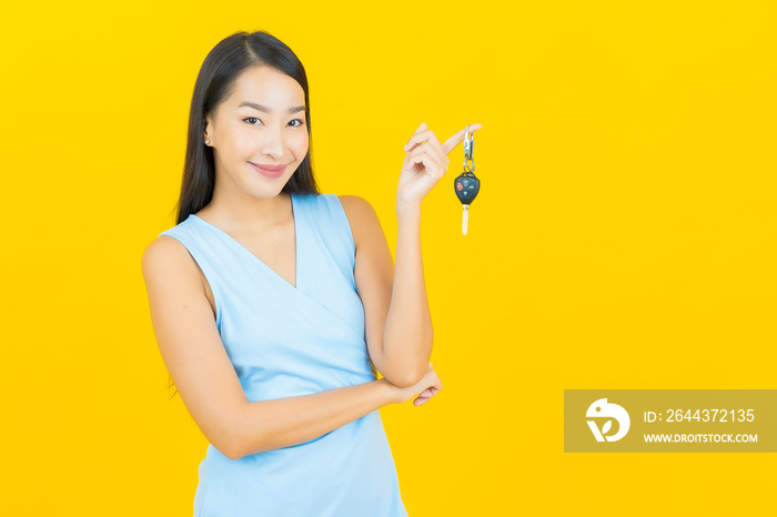 Portrait beautiful young asian woman smile with car key