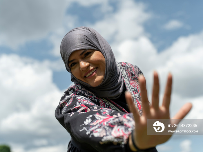 UK,Sutton,Portrait of smiling woman in traditional dress and headscarf