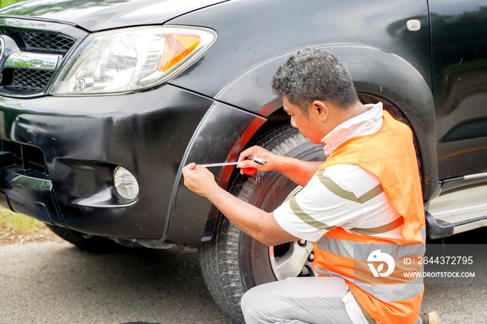 Insurance company officer checking car damages after car accident.