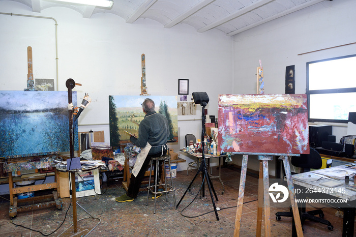 Painter artist painting a picture in the studio