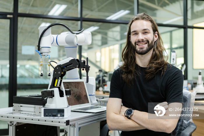 Male staff engineer sitting crossed arms with robot for education ontable at class room. education classroom for future robotics learning innovation. Man workshop maintenance technical.