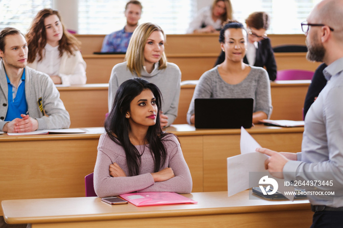 Lecturer and multinational group of students in an auditorium