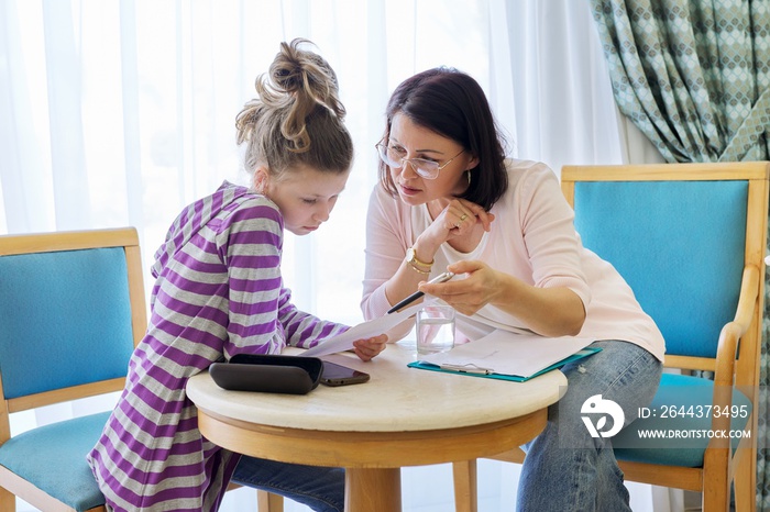 Pre-adolescent girl at consultation with social worker in office