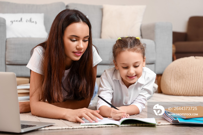 Cute girl studying with tutor at home