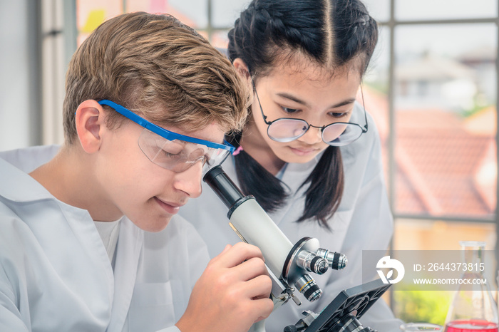 students using microscope in science laboratory class