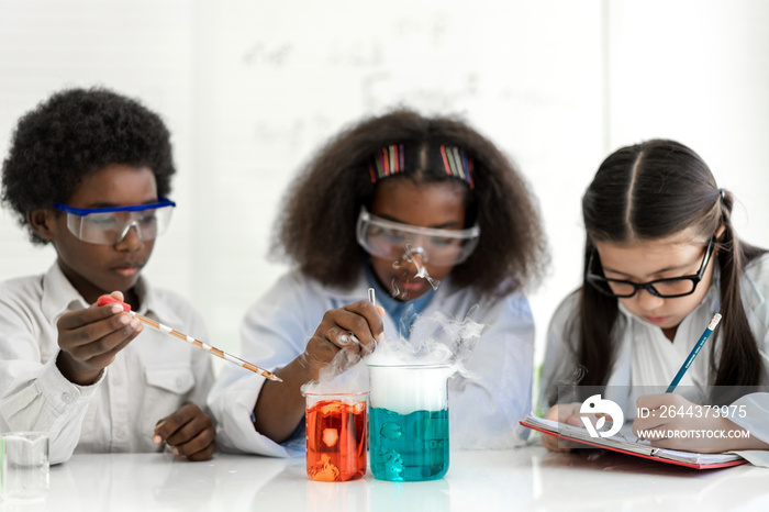 Group of teenage student learn science with teacher and study doing a chemical science experiment and holding test tube in hand in the experiment laboratory class on table at school.Education