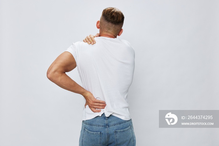 Man back pain neck and joints, bone and spine problems, inflammation and trauma, in white T-shirt on white isolated background, copy space