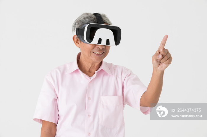 Portrait of full energy and active senior older Asian man wearing virtual reality device on head and enjoy with game and entertainment. VR new technology learning concept for old people