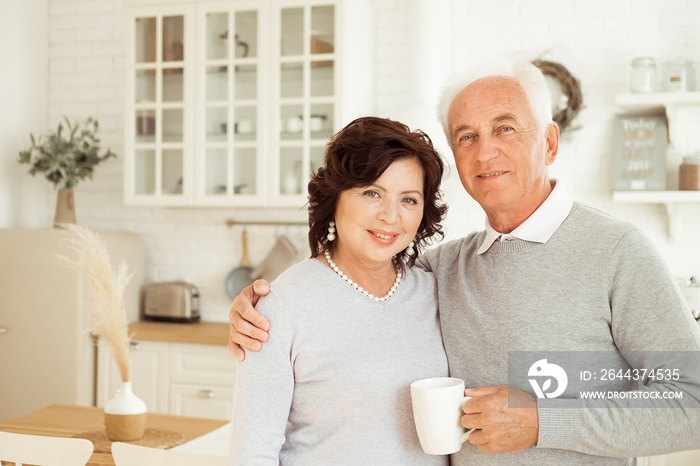 Happy old couple having coffee together