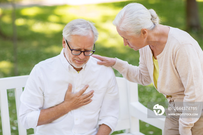 senior man feeling sick at summer park