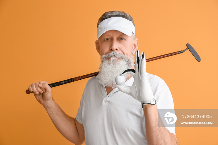 Sporty elderly golf player on color background