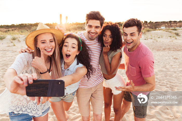 Group of cheerful young friends in summer clothes