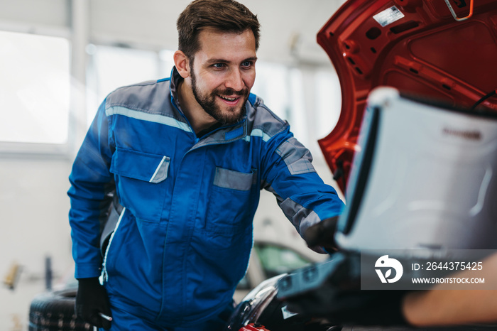 A professional mechanic working in a car service.