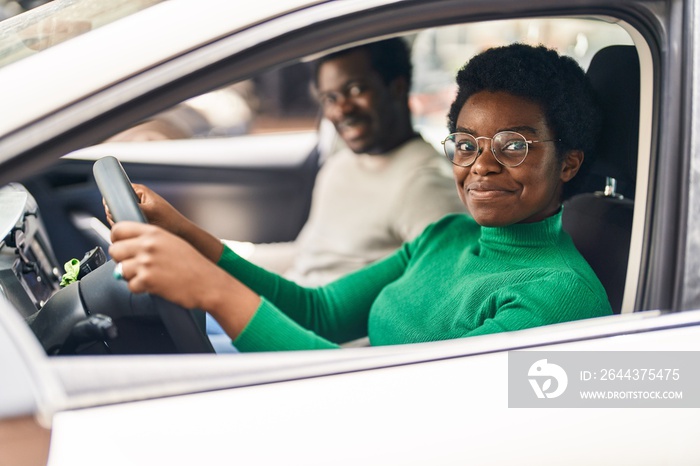 African american man and woman couple driving car at street