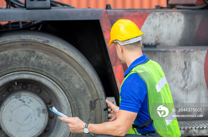 Mechanics checking wheel in cargo container. Professional technician pre-check forklift truck tires, safety concept.