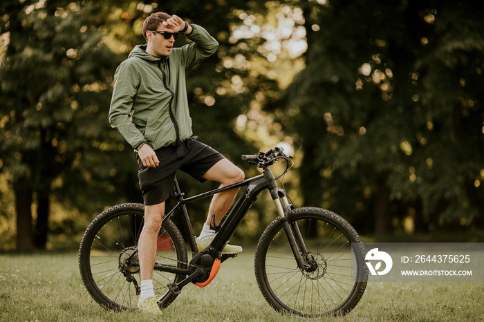 Young man riding ebike in nature