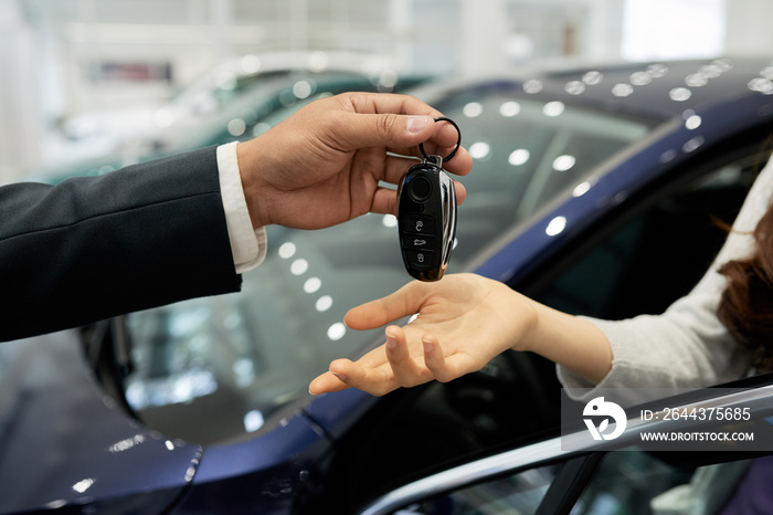 Salesman giving electronic car keys