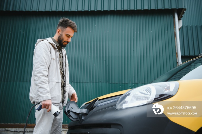 Man charging his electric car.