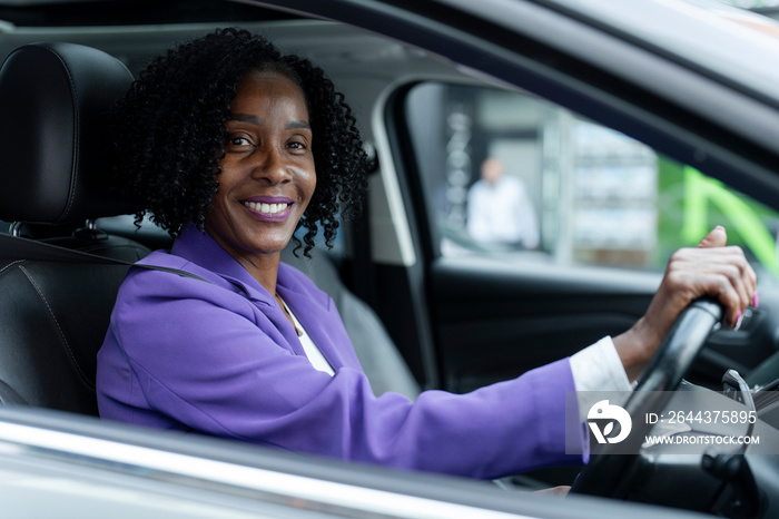 Portrait of smiling woman driving car