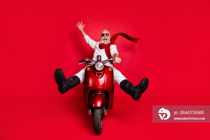 Full body photo of funky retired person screaming driving bike wearing white jumper boots pants trousers isolated over red background