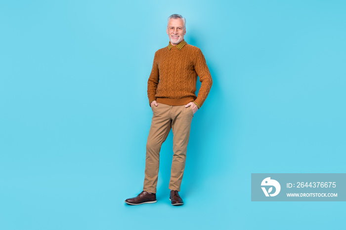 Photo of positive cheerful man put hands pockets isolated over sky light color background