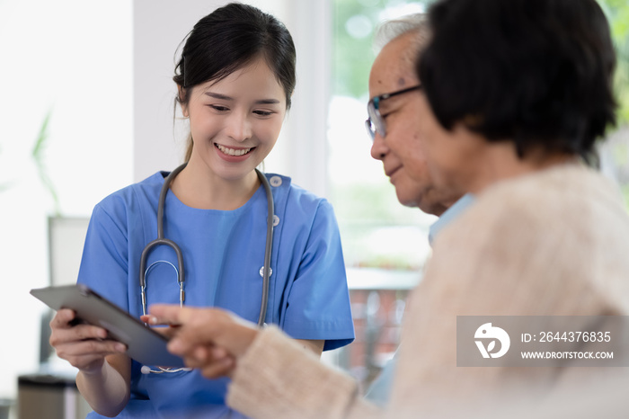 Asian woman doctor work in nursing home with digital tablet consults service to patient explains health care symptoms and help elderly family, Concept of elderly care, health care and insurance.