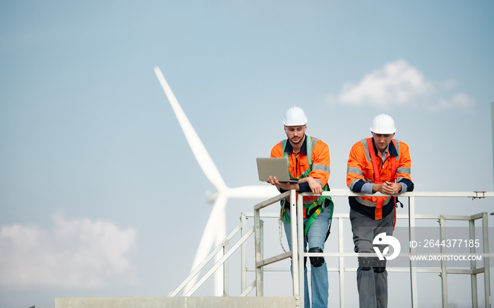 Surveyor and engineer Examine the efficiency of gigantic wind turbines that transform wind energy into electrical energy that is then used in daily life.