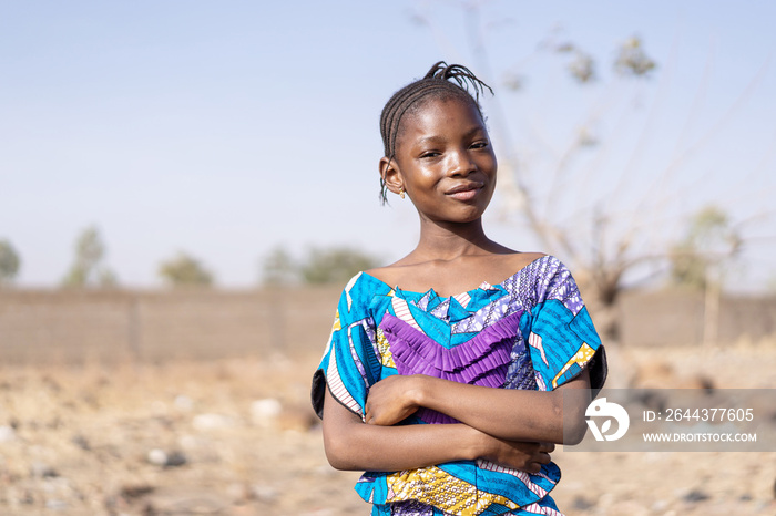 African beauty little girl posing for the camera with uniform defocused background