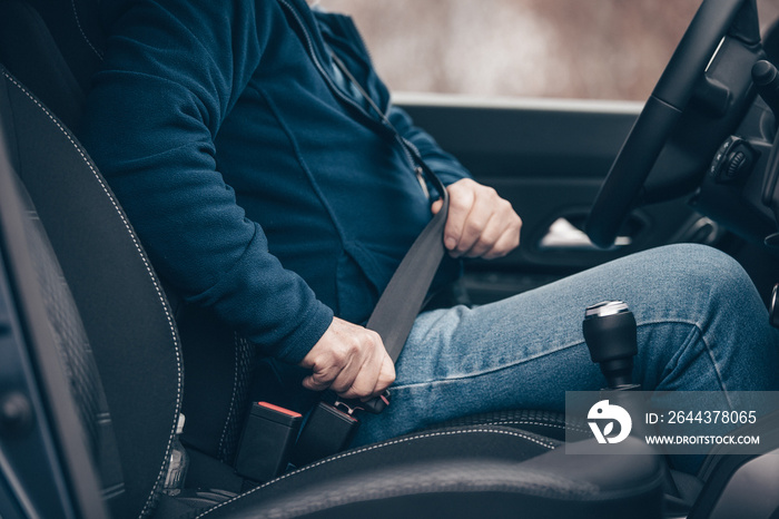 passenger  senior man fastening seat belt in the car, transport and  safety concept