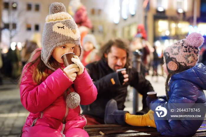 Family with kids attending the celebration of Restoration of the State Day in Vilnius, Lithuania. Bonfires are lit on Gediminas avenue on the night on February 16.