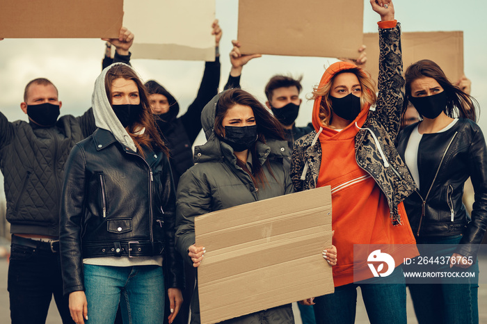 A group of people with mask and posters to protest The protest of the population against coronavirus and against the introduction of quarantine Meeting about coronavirus and people rights. copyspace