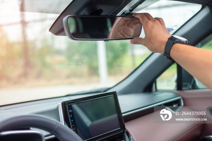 man driver adjusting rear view mirror a car. Journey, trip and safety Transportation concepts