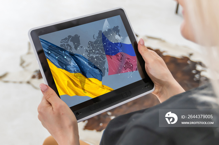 young journalist with tablet news, flag of russia and ukraine