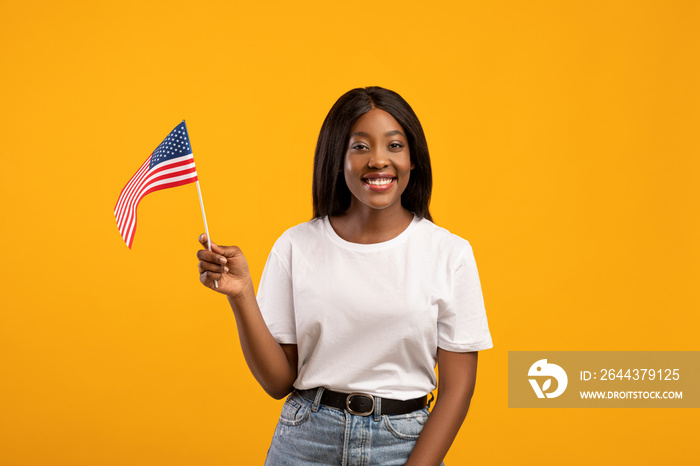 Positive black woman student holding american flag