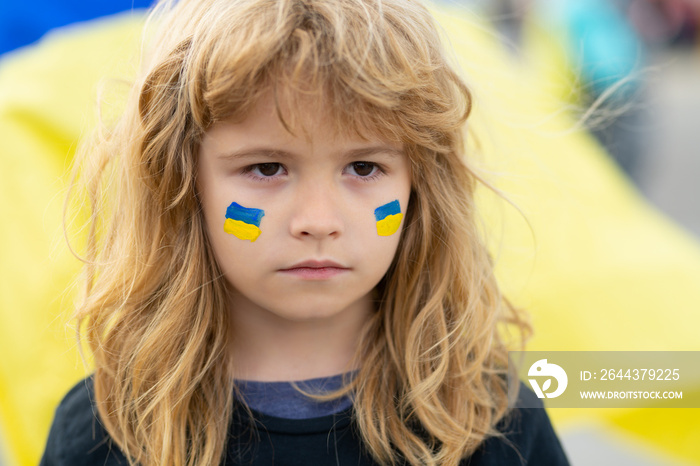 Ukraine flag on children cheeks. Human protest.