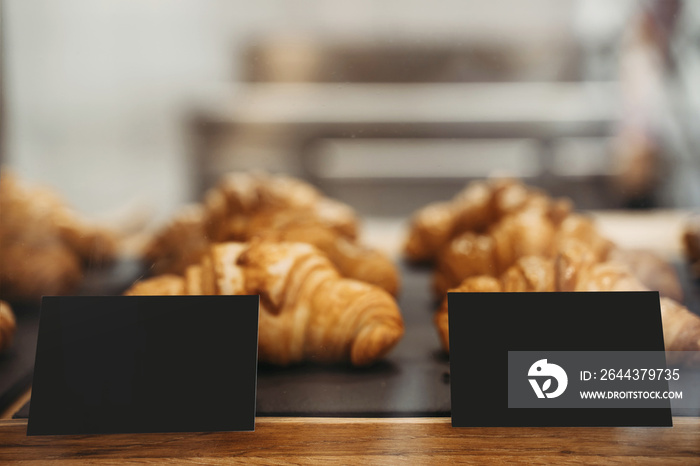 Interior details at the bakery and coffee shop. Bistro showcase with shelves of freshly croissants and bread in assortment.