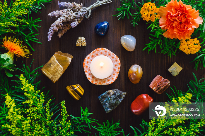 Lit Candle with Stones and Flowers of Summer