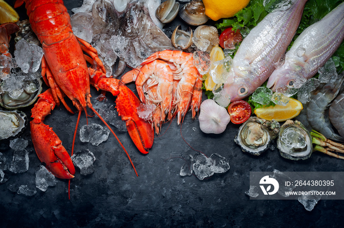 Shellfish and crustacean seafood with selection of fresh lobster, shrimp, fish, oyster, squid and crab on dark rustic background.