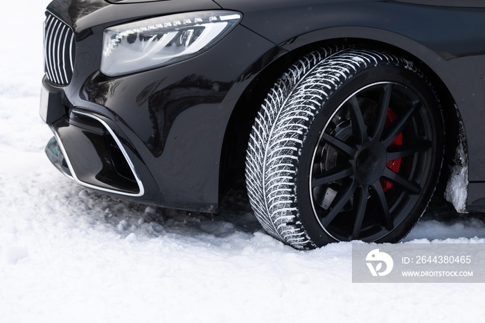 tire on a winter snow-covered road in winter landscape