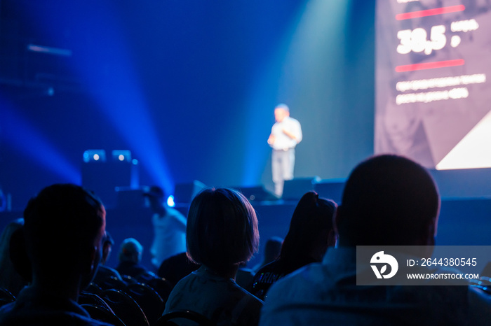 Unrecognizable people listening to speaker during business conference