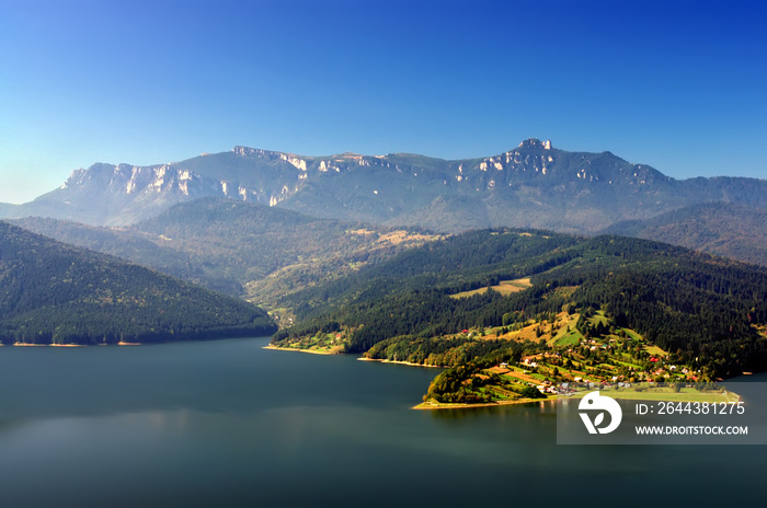 Lake and meadow in countryside of Romania, Bicaz and Ceahlau mountain