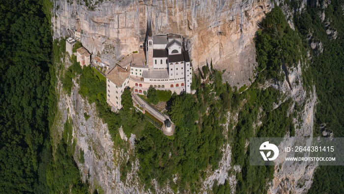 Church in the rock, Santuario della Madonna della Corona. An old church, built around 1625, on the slope of the cliff. Madonna della Corona Sanctuary aerial panorama, surrounded by mountains