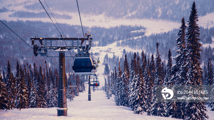 Landscape mountain ski lift resort in winter forest sunset, aerial top view Kemerovo region Russia