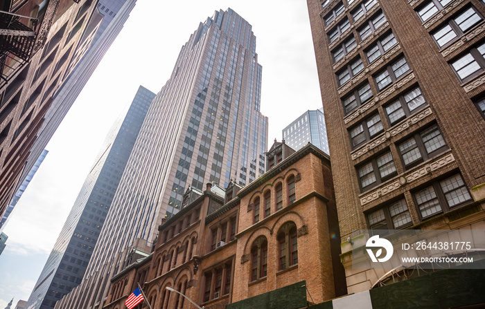 New York, Manhattan. High buildings view from below against blue sky background