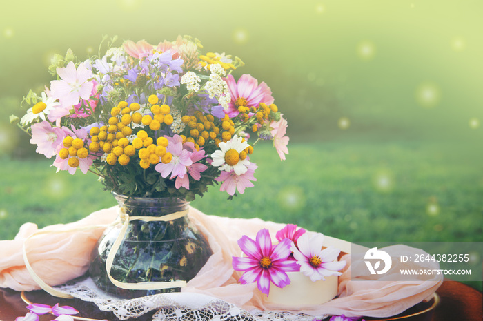 Wildflowers bouquet in a vase. Summer background.