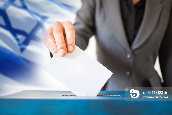 elections in Israel. Hand of a woman putting her vote in the ballot box. Waved Israel flag on background.