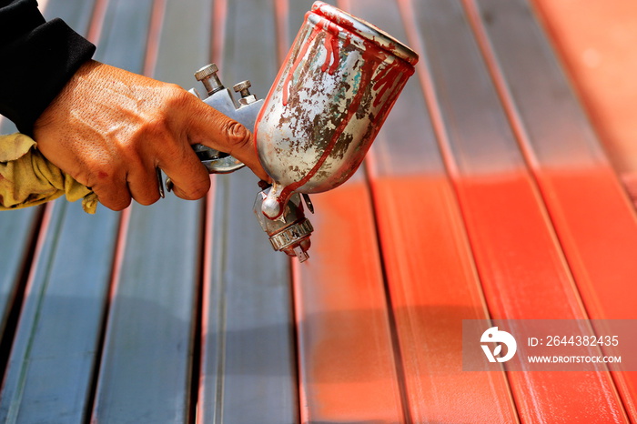 People are working with spray paint to prevent rust.