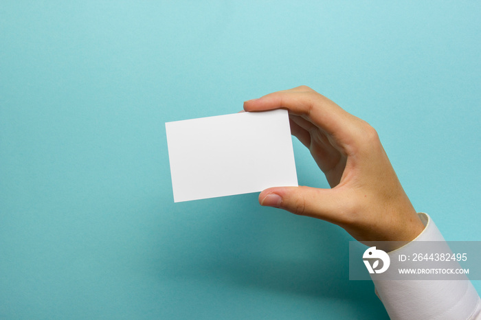 Hand holding business card blank on abstract background