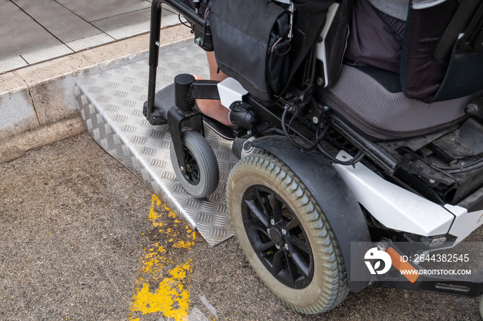 Ramp for disabled persons on wheelchair at building entrance.